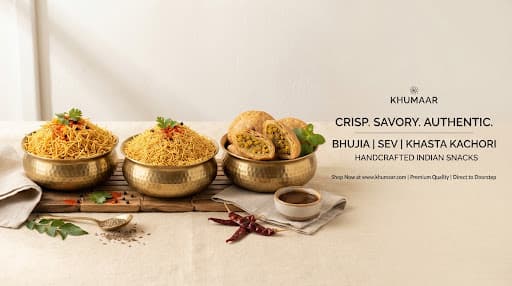 Premium Indian namkeens and snacks arranged in elegant brass bowls